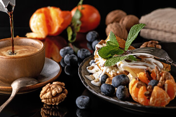 Still life. Coffee and a delicious breakfast of pancakes with cheese and fruits: blueberries, oranges and nuts