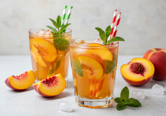 Refreshing peach fizz cocktail with mint and ice on white background