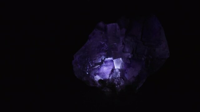 Purple fluorite stone illuminated with black background