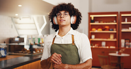 Music, man and barista with headphones in cafe, streaming radio and idea for hip hop playlist in...