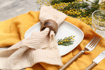 Beautiful table setting with mimosa flowers on grey background, closeup