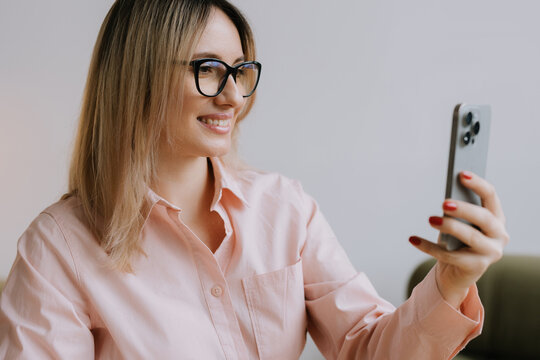 Woman using phone for an online meeting