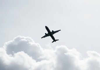 Obraz premium Aircraft soars among fluffy cloudscape, traveling through the sky for airline flight travel, vacation and summer holiday adventures, with copy space