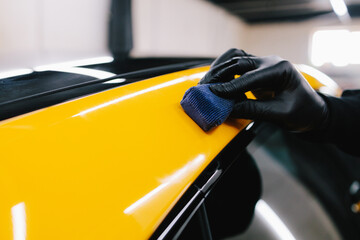Process of applying a ceramic coating to the sports car surface for protection during detailing...