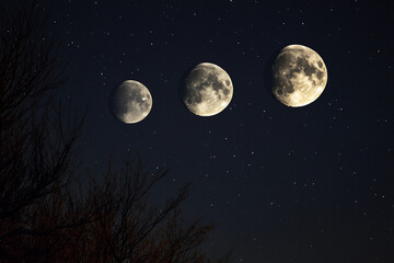 Three full moons shining brightly in a starry night sky
