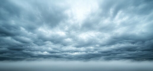 Obraz premium Dramatic Storm Clouds Over a Foggy Landscape, A Sky of Ominous Beauty