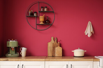 Fototapeta premium Modern counter with coffee machine and cooking utensils in interior of stylish kitchen