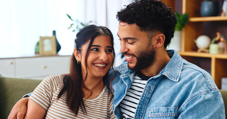 Fototapeta premium Home, smile and couple on couch, hug and bonding together with happiness, calm and romance Embrace, apartment and man on sofa with woman, love and support with relationship and marriage in lounge
