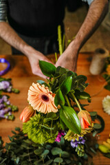 Florist arranging a beautiful bouquet of fresh flowers