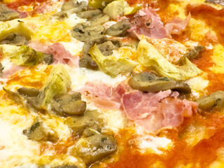 Delicious mushroom artichoke and ham pizza with melted mozzarella