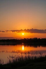 Obraz premium araffes are standing on the shore of a lake at sunset