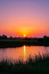 sunset over a lake with a small boat in the water