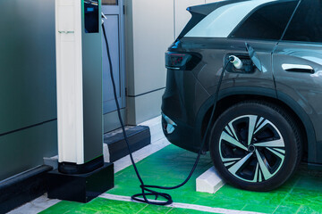 Electric car charging at a charging station in the city.