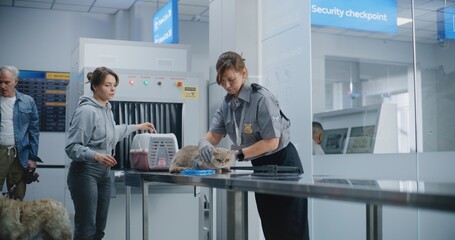 Airport Terminal: Woman with Pet at Security Checkpoint. Female Security Officer Scanning Cat Using...