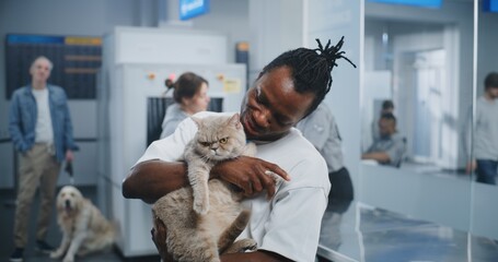 Airport Terminal: Portrait of Happy African American Man Holding His Cat, Smiling and Looking at...