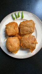 Golden fried food is arranged on a decorative white plate
