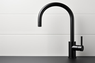 Matte black modern kitchen faucet with a sleek curved design. This stylish faucet adds contemporary touch to kitchen interiors with its minimalist structure.