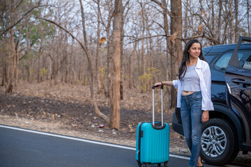Young girl traveler waiting outside the car with backpack.