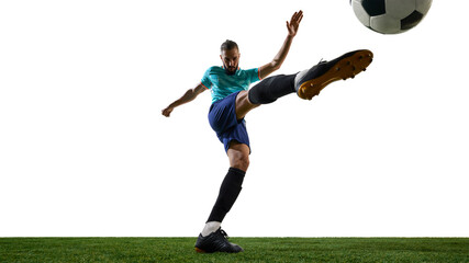 Dynamic photo of football athlete with focused expression executing powerful shot, fully stretched,...