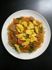 A Plate Presents Noodles with Egg and Various Meat Ingredients