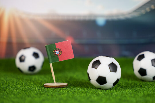 portugal football scene with portuguese flag, soccer balls on green field, and stadium, symbolizing national pride, sports culture, and competitive spirit