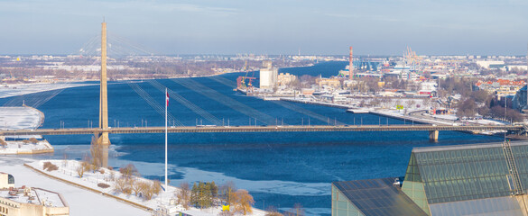 Aerial view of Riga, Latvia, in winter, showing the Vansu Bridge over the Daugava River, the...