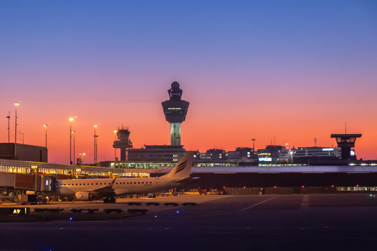 Schiphol Airport at night with parked overnight layover aircraft at gate
