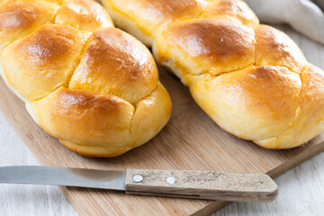 Traditional Easter braided bread. Tsoureki braid on white wooden table