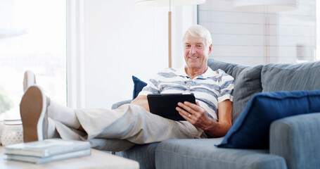 Fototapeta premium Sofa, senior man and portrait with tablet for online game, web surfing and reading ebook at home. House, elderly person and relax on couch with digital poker, social media or connection in retirement