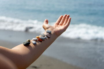 Stones on the hand on the sea background