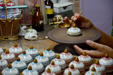 Thai people woking process paint Ceramic Benjarong is traditional thai five basic colors style pottery