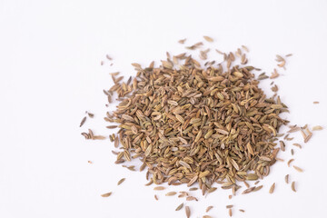 Closeup fennel seeds on bowl isolated on white by top view. Heap pile of dried fennel dill seeds