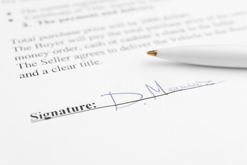Fototapeta premium Ballpoint pen and signature on contract, closeup