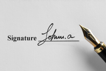 Fountain pen and signature on contract, top view