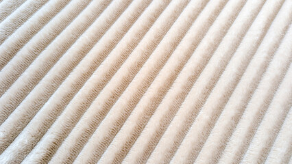 Luxurious beige textile featuring diagonal stripes, creating soft velvety texture with refined...