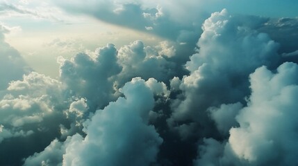 Naklejka premium Aerial view of fluffy clouds illuminated by sunlight.