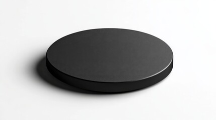 This image features a sleek black circular object sitting on a clean white background, emphasizing minimalism and modern design aesthetics for various uses in digital media.