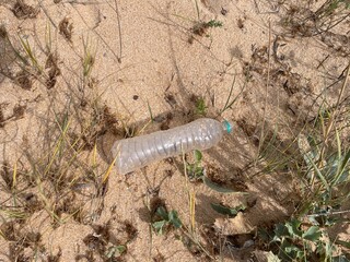 Plastic bottle washed up on the sand
