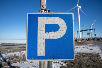 weathered parking lot sign with white letter P on blue
