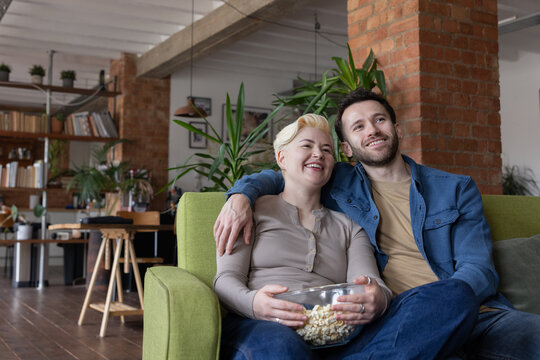 Couple Enjoying Movie Night Together on Sofa