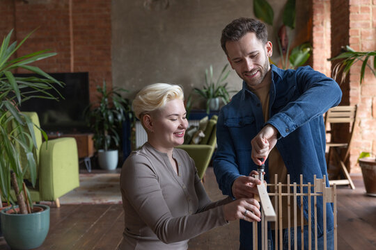 Couple Building Together with a Smile and Tools