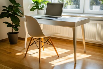 Modern workspace with laptop, plants and chair