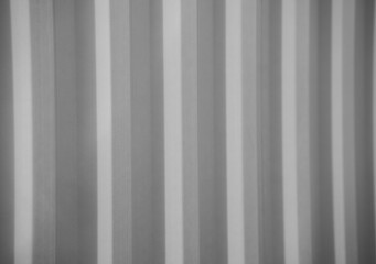 Obraz premium black and white image of vertical lines of side of corrugated metal of an industrial container horizontal image for backdrop background linear concept design light and dark greys and shadows