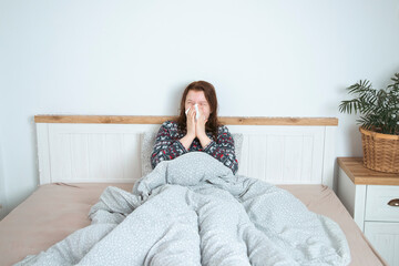Obraz premium Sick child at home in bed. Acute respiratory viral infection.