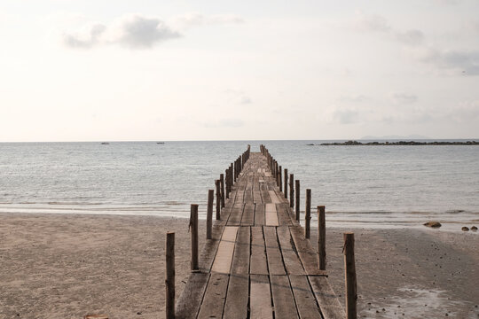 wooden pier on the beach - Powered by Adobe
