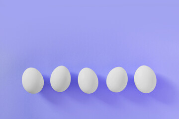 Frame of Easter white natural eggs set isolated on pastel pink background. Stylish trendy composition with chicken egg. Flat lay, top view, place for text. Happy eco-friendly holiday, minimal concept