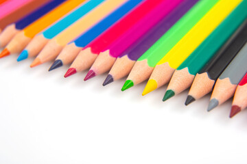 A vibrant collection of colored pencils in a straight line on a white background. Perfect for art education, stationery, or creative inspiration themes.