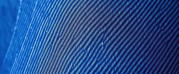 Close-up of raw, unwashed denim showing deep indigo hues and textured weave, grunge, textile background