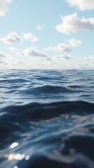 Fototapeta premium A serene view of calm ocean waters under a bright blue sky with fluffy clouds.