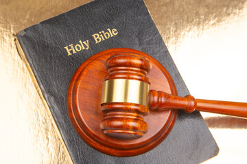 A traditional gavel sits on an open 